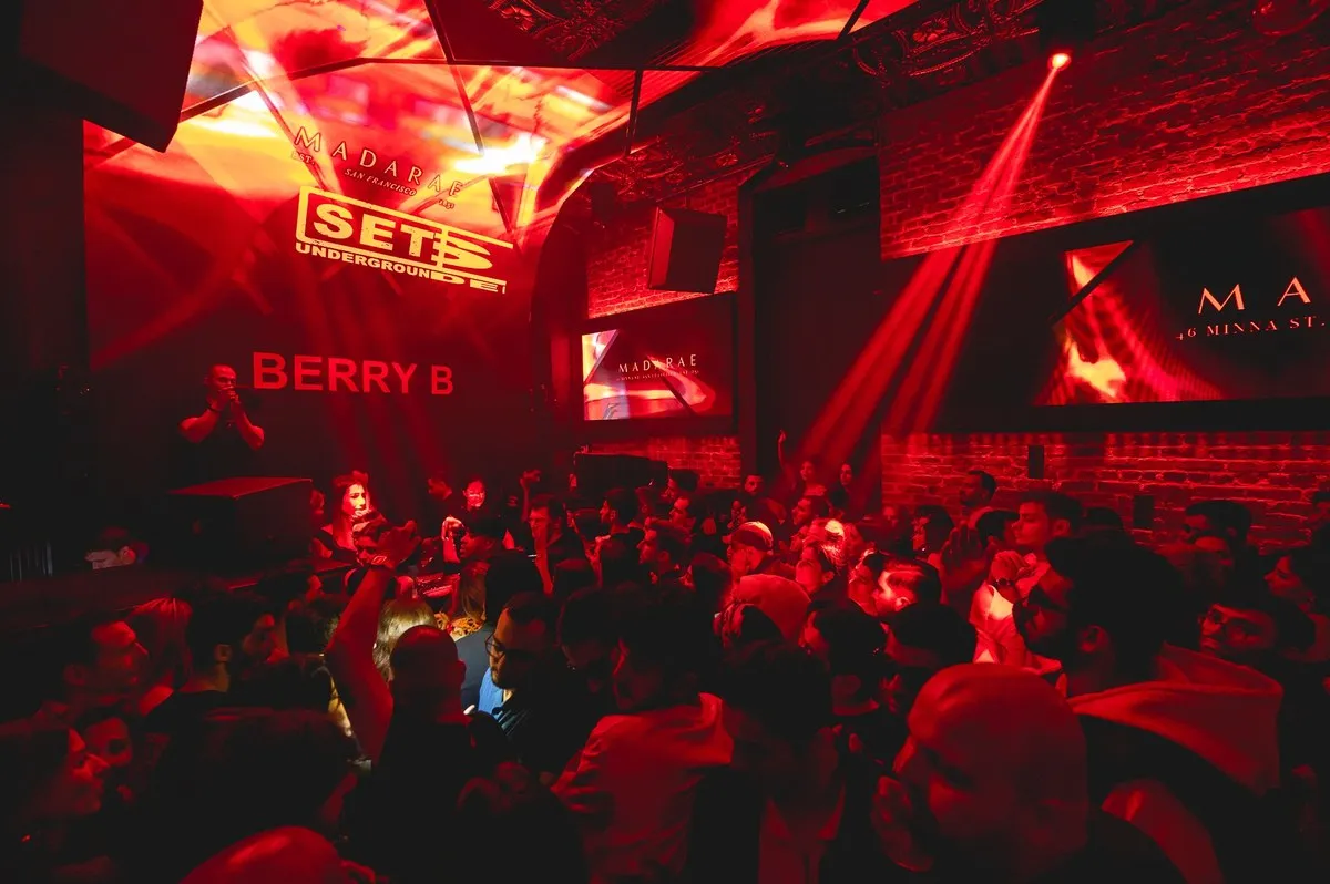 Red-lit club with laser lights