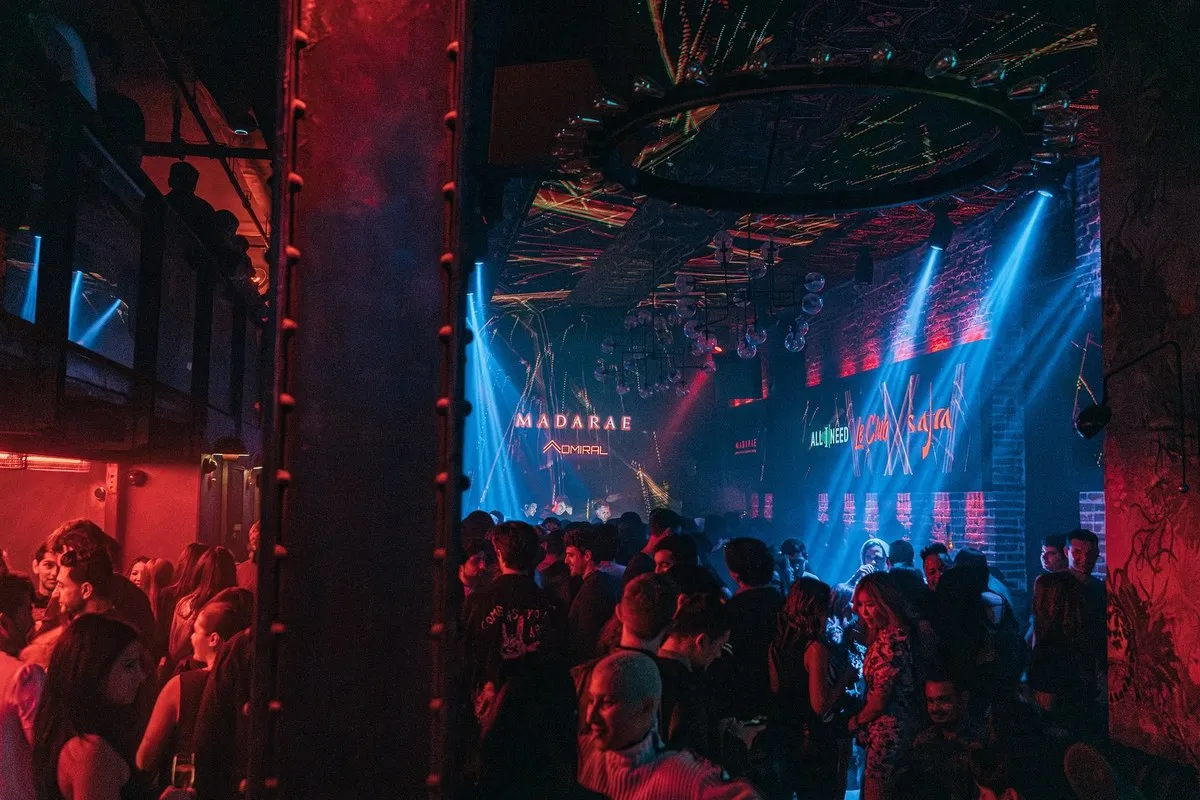 Blue-lit dance floor and crowd