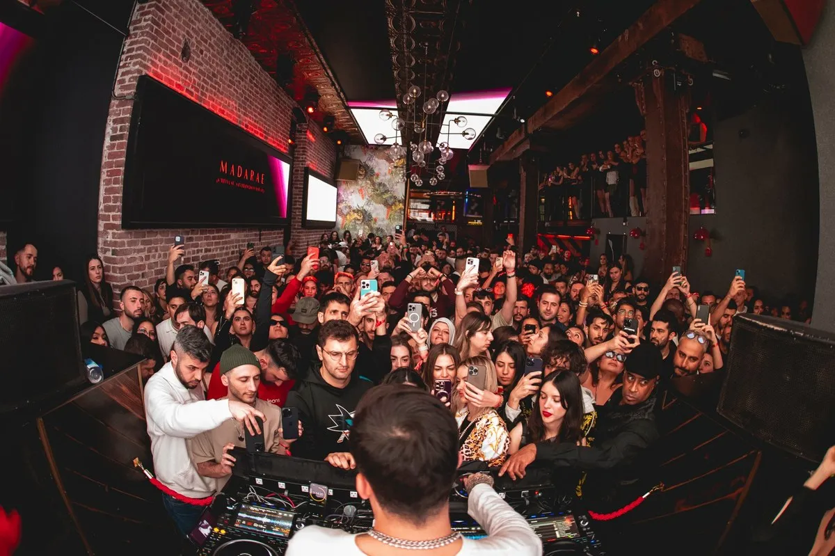 Packed dance floor seen from the DJ booth